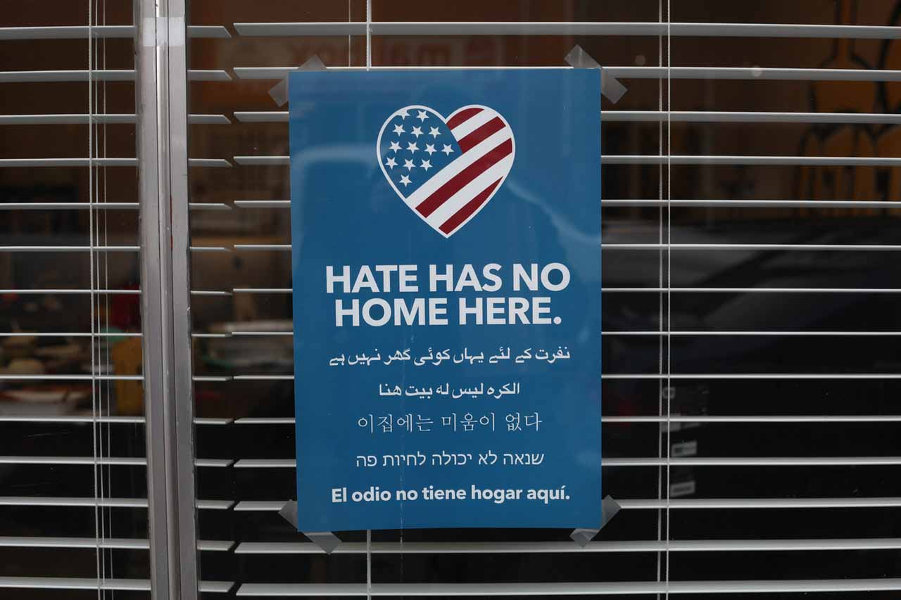 US flag in the shape of love with text: Hate has no home here